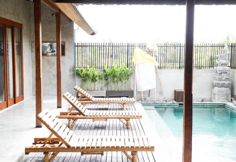Kano Canggu pool area with comfortable loungers